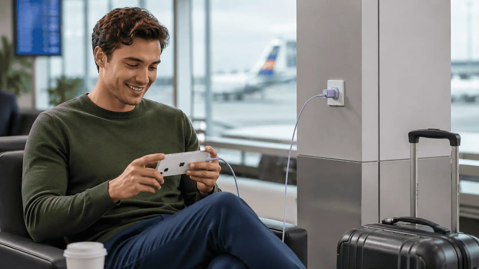 Anker 511 Nano 4 30W USB-C charger GaN charger charging a phone from an airport wall socket while travelling