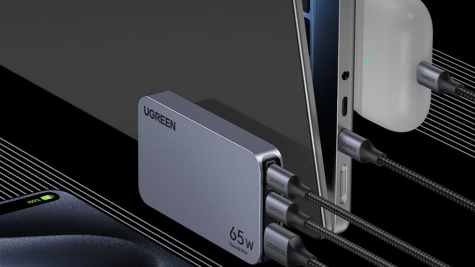 UGREEN Nexode Pro 65W GaN charger powering a laptop, phone and earbuds from its three ports