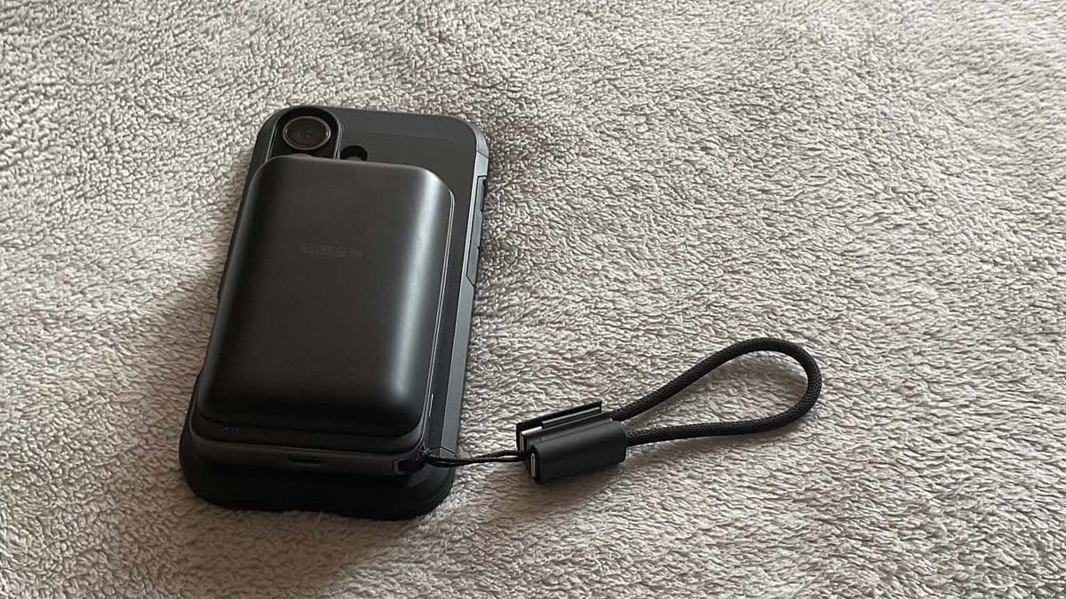 LISEN Qi2.2 power bank held magnetically on the back of an iPhone 17