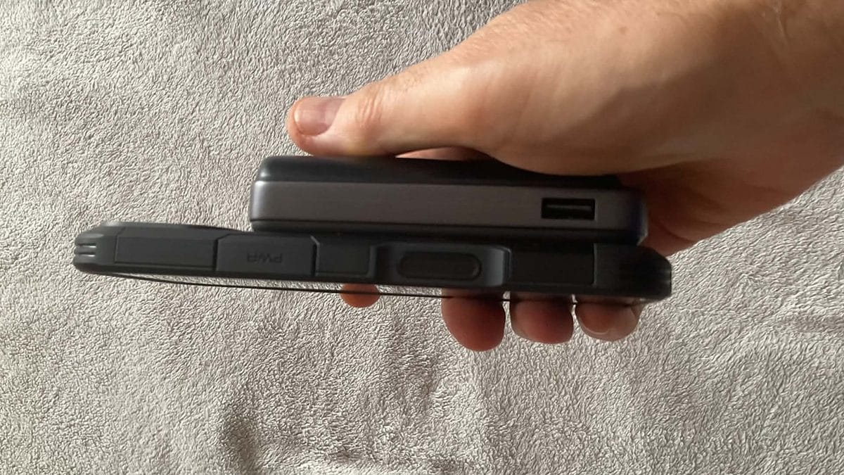 LISEN 10000mAh MagSafe power bank in hand next to an iPhone for scale